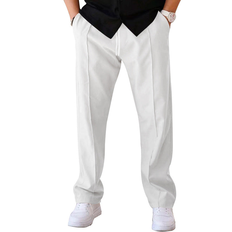 Man in stylish grey sweatpants enjoying outdoor casual activity, blending comfort &amp; fashion.