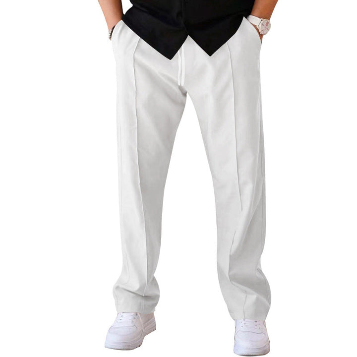 Man in stylish grey sweatpants enjoying outdoor casual activity, blending comfort &amp; fashion.