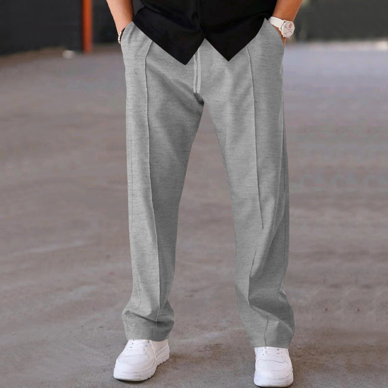 Man in grey relaxed fit sweatpants, demonstrating effortless style &amp; comfort for everyday.